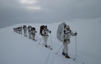 group of men on skis dressed in white