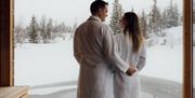 couple on a floating sauna in winter