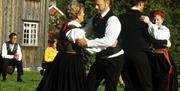 people in bunad dancing at the Tinn Museum