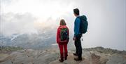 couple on top of Gaustatoppen in foggy weather