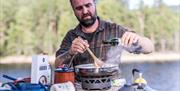 man cooking at Sandviken Camping